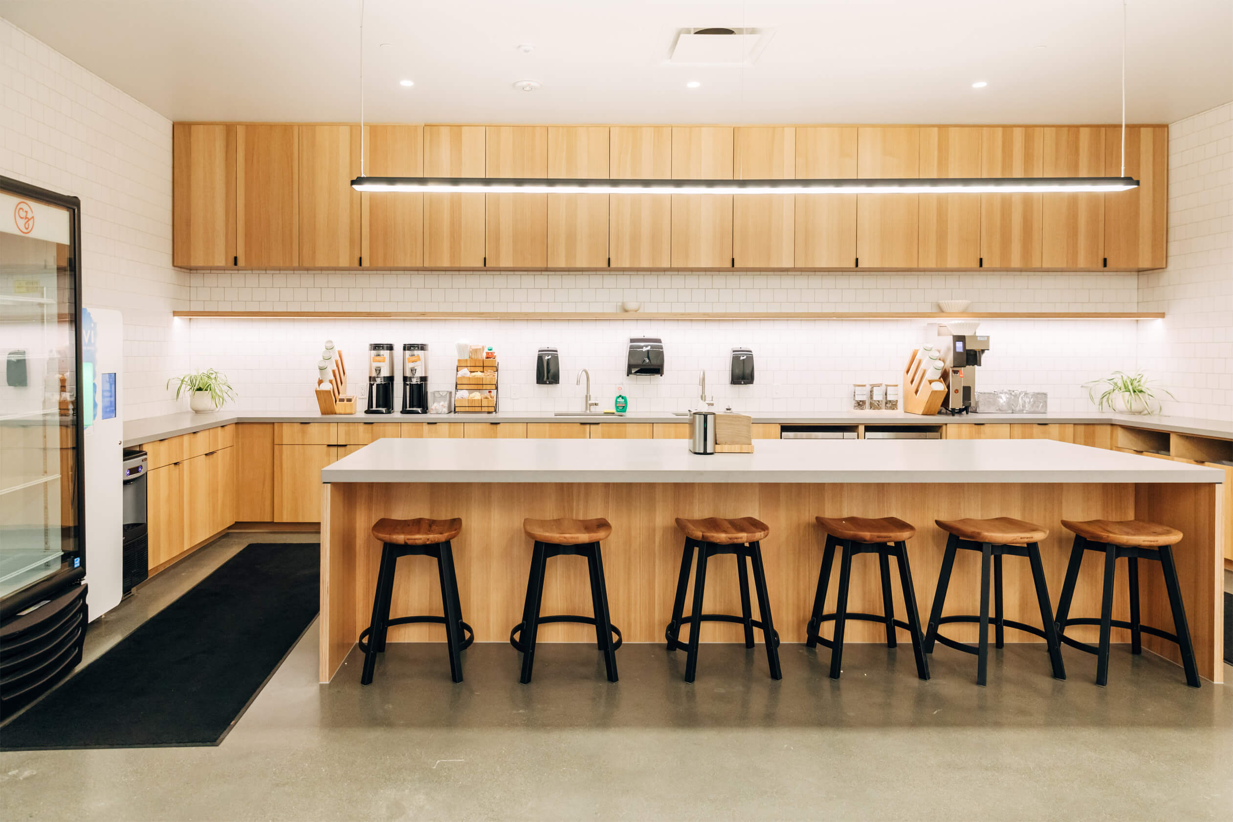 Bright kitchen space with island and six stools.
