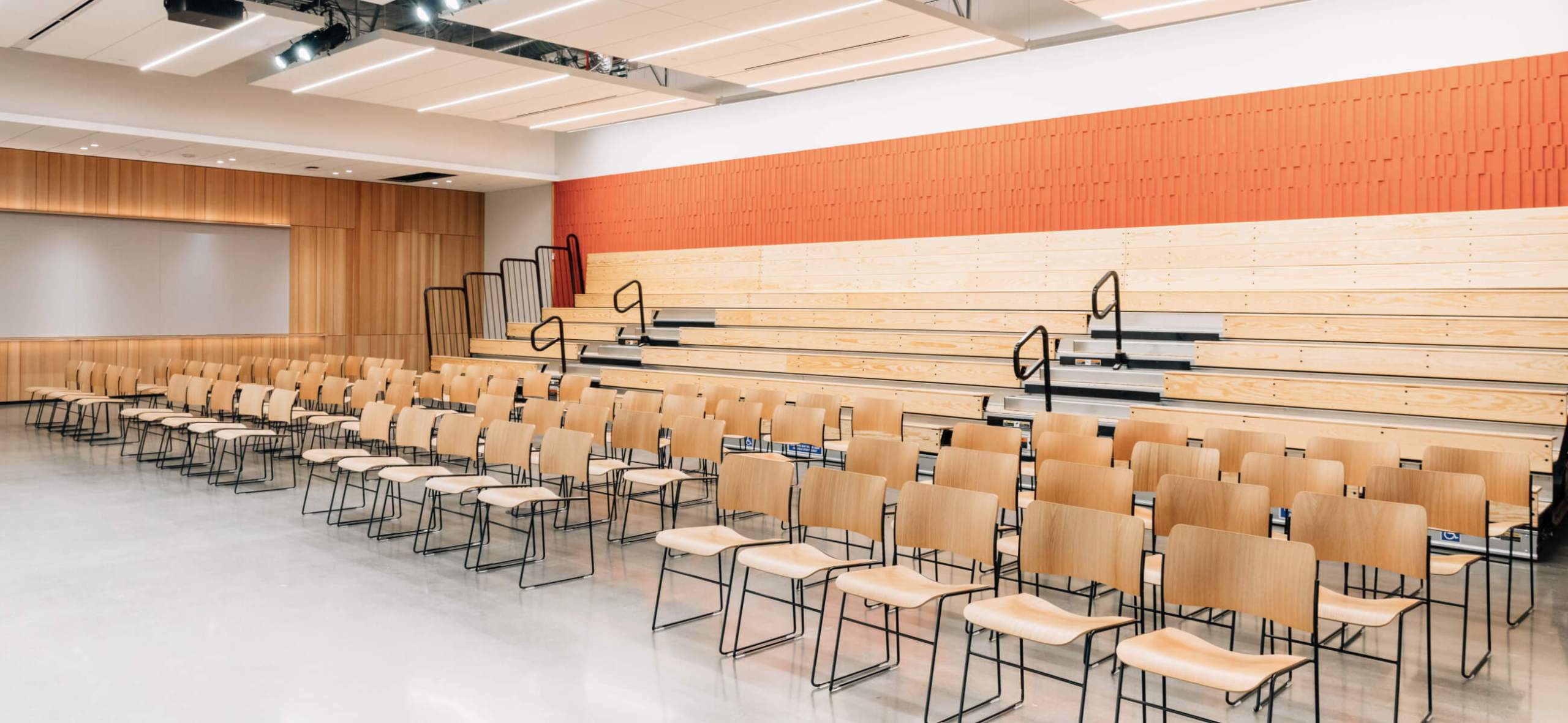 Photo of CZI Community Space main event space, showing rows of chairs and bleachers.