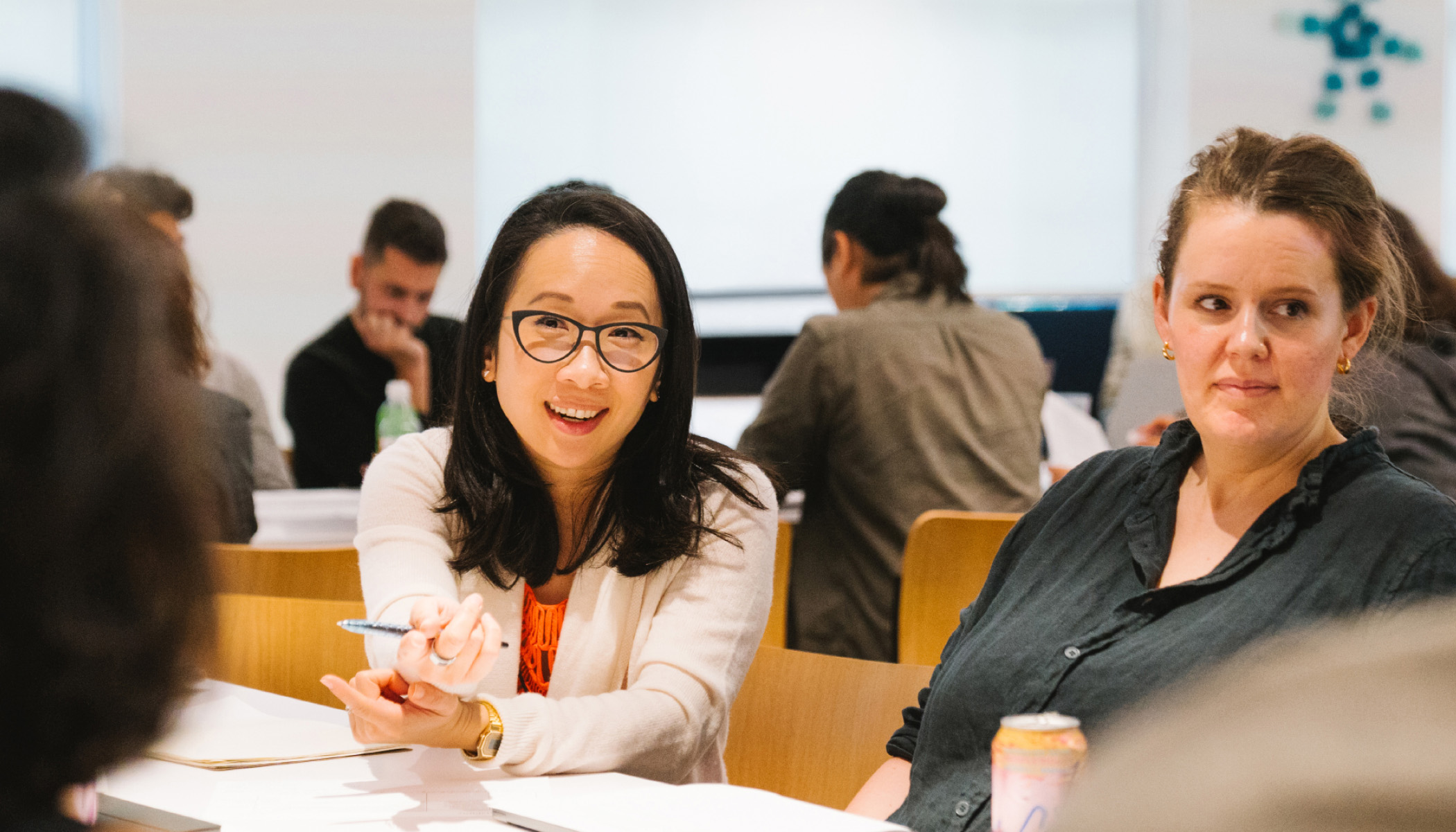 Sandra Liu Huang sits at a table with CZI colleagues